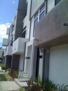 Modern townhouses with open house sign.