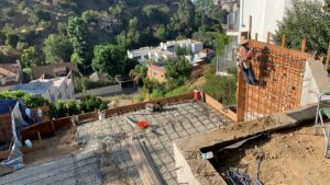 Residential construction site with builder and reinforcing bars.