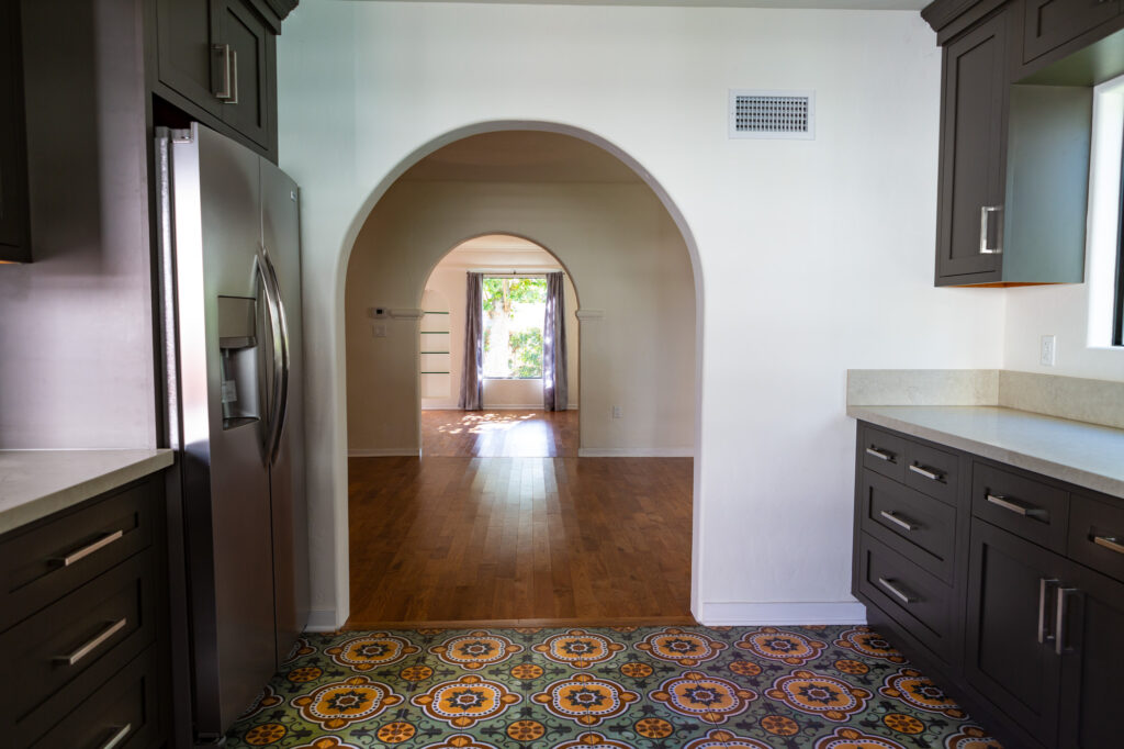 Kitchen interior with archway and patterned rug.