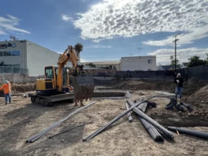 Construction site with excavator and workers during daytime.
