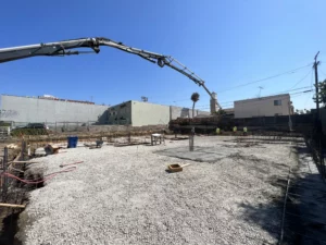Construction site with concrete pump and workers.