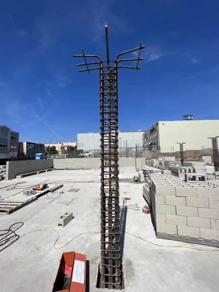Rebar structure at construction site against blue sky