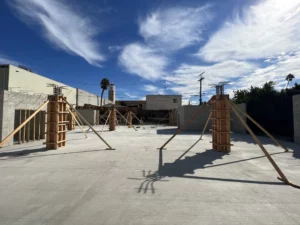 Construction site with new concrete foundation and wooden forms.