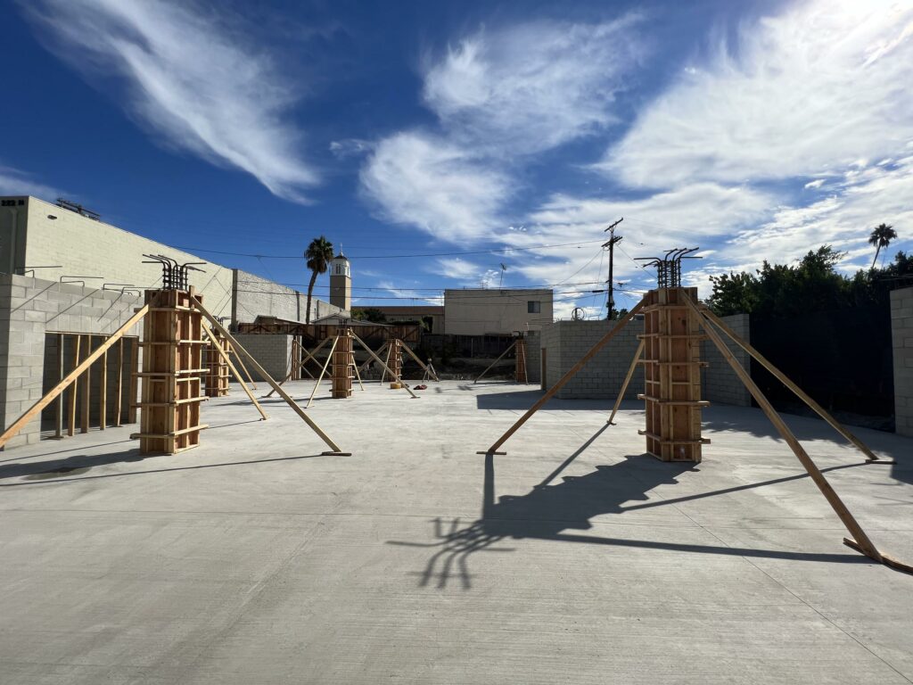 Concrete foundation with wooden construction frames and blue sky
