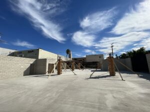 Sunny day at industrial construction site with blue sky.