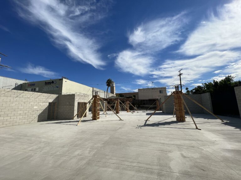 Sunny day at industrial construction site with blue sky.