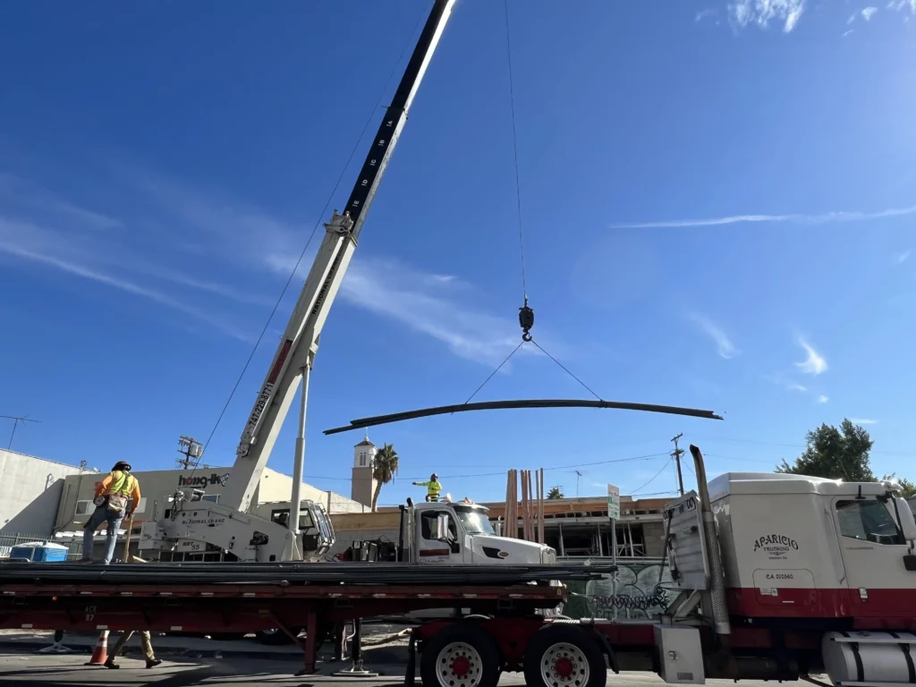 Crane lifting material at construction site