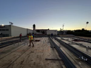 Workers on construction site at sunset