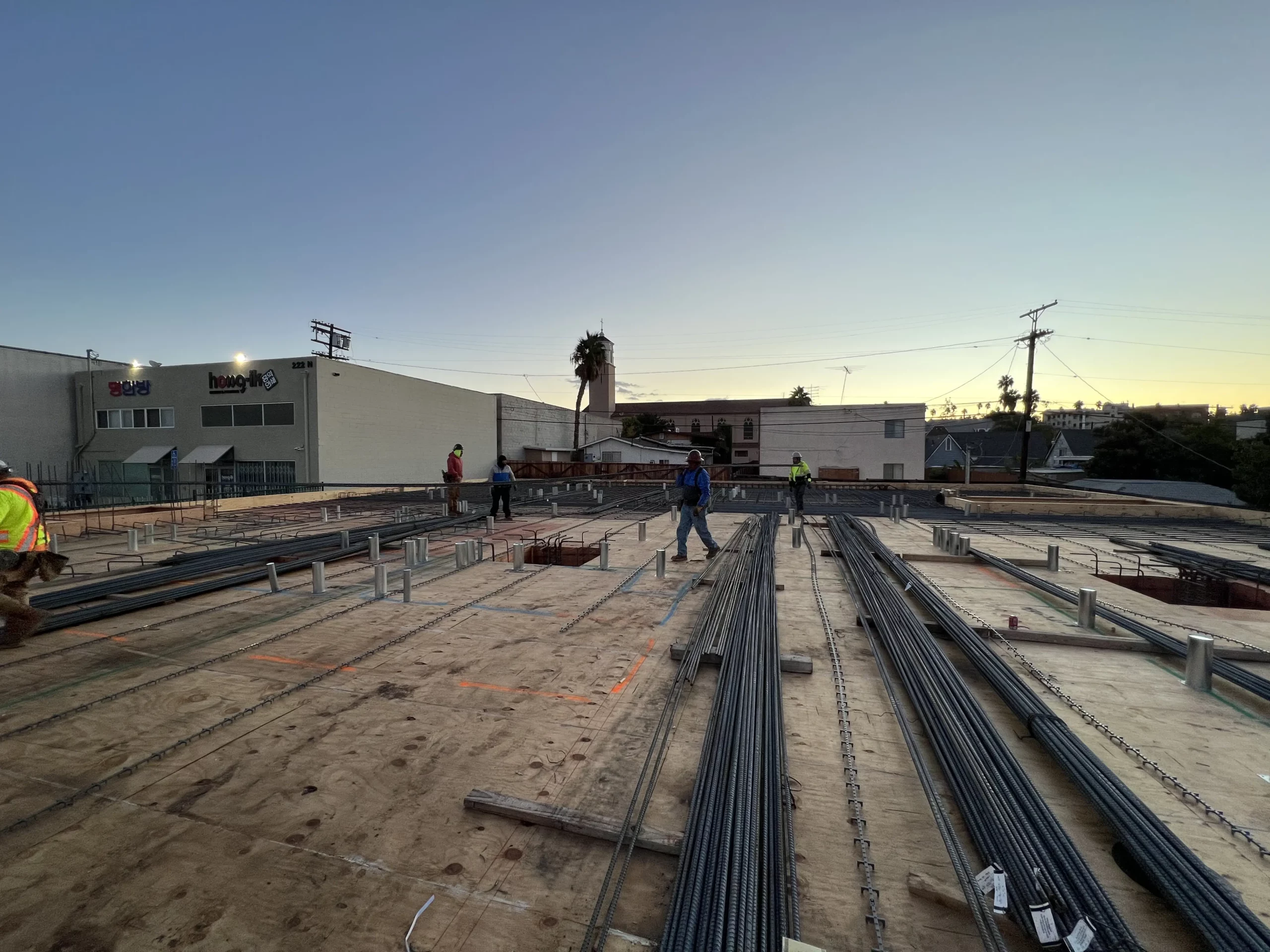 Construction workers at an early morning building site.