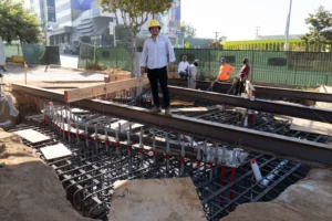 Construction workers at building foundation site.