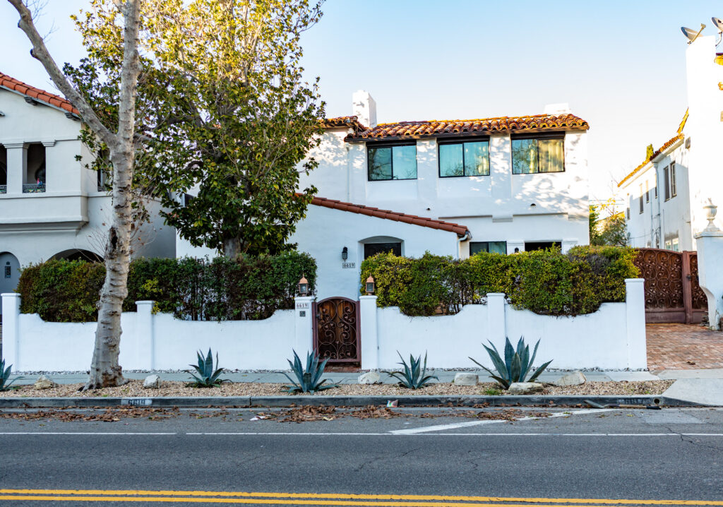 Spanish-style home with tiled roof and white walls.