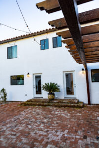 Spanish-style home exterior with string lights.