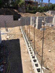 Construction site with concrete block wall foundations.