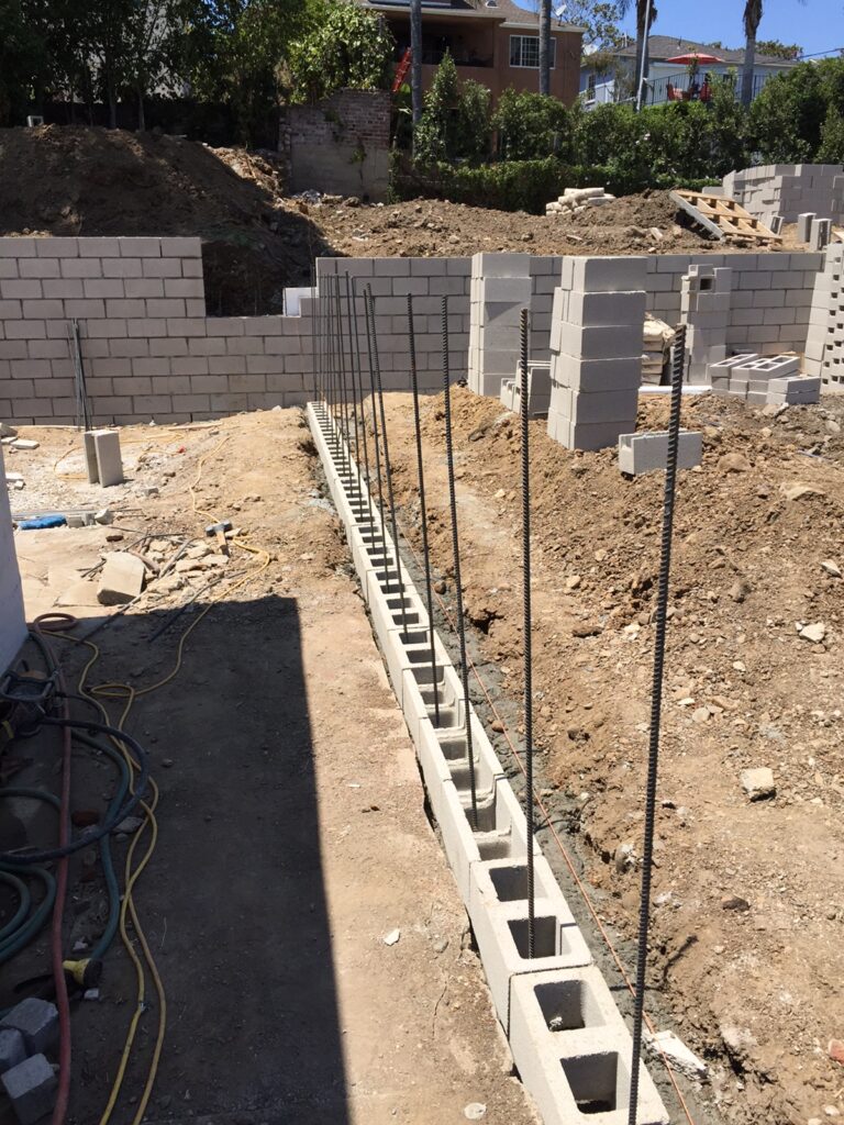 Construction site with concrete block wall foundations.