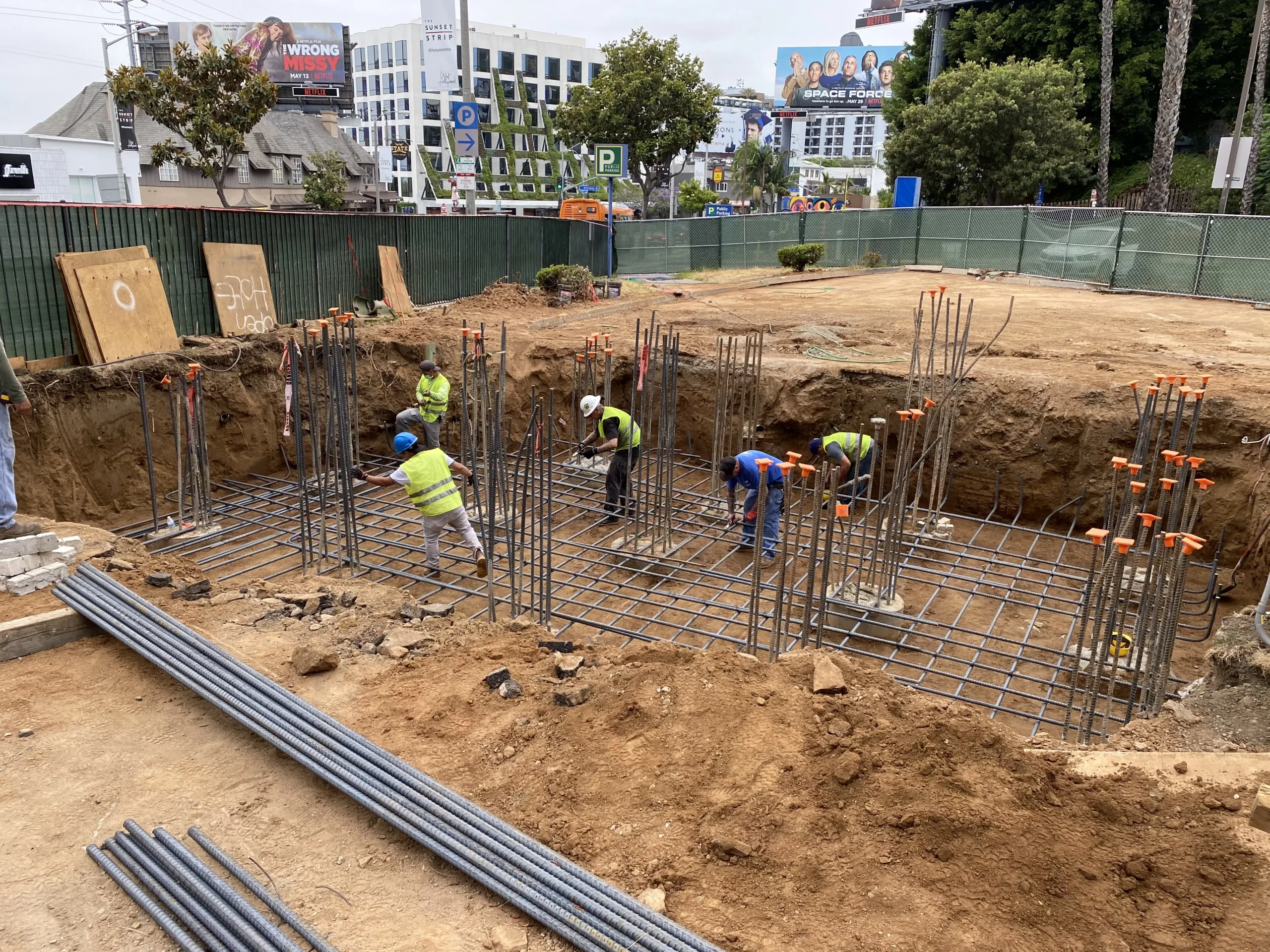 Construction workers at a building foundation site.