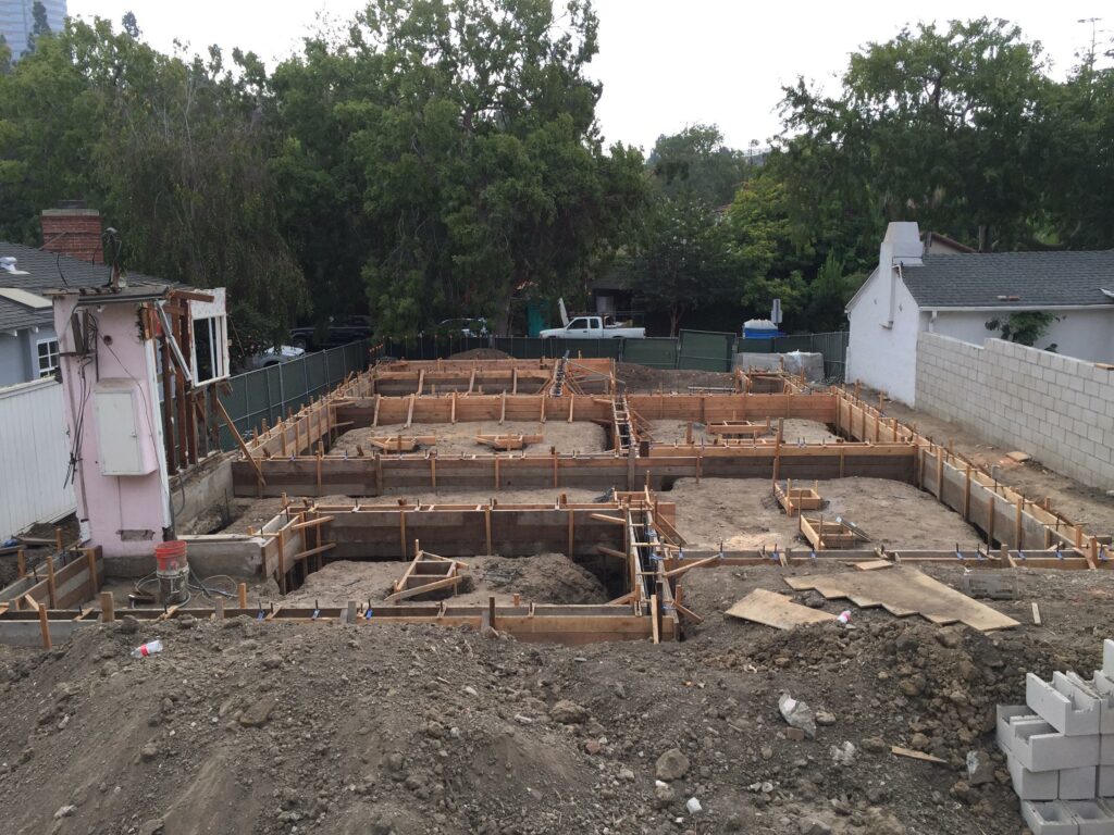 Residential foundation construction site with wooden forms.
