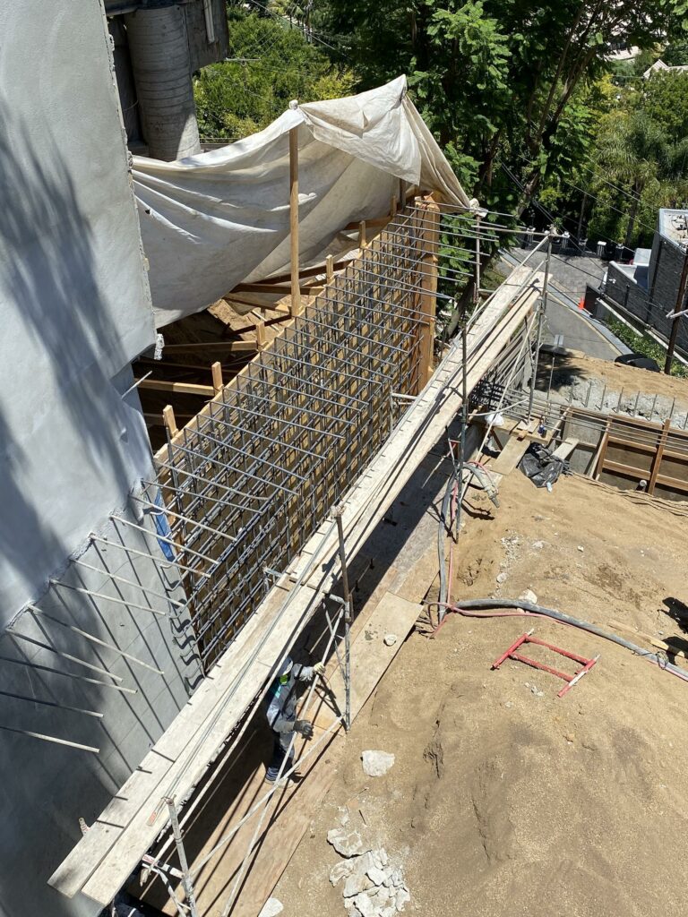 Construction site with rebar framework and scaffolding.