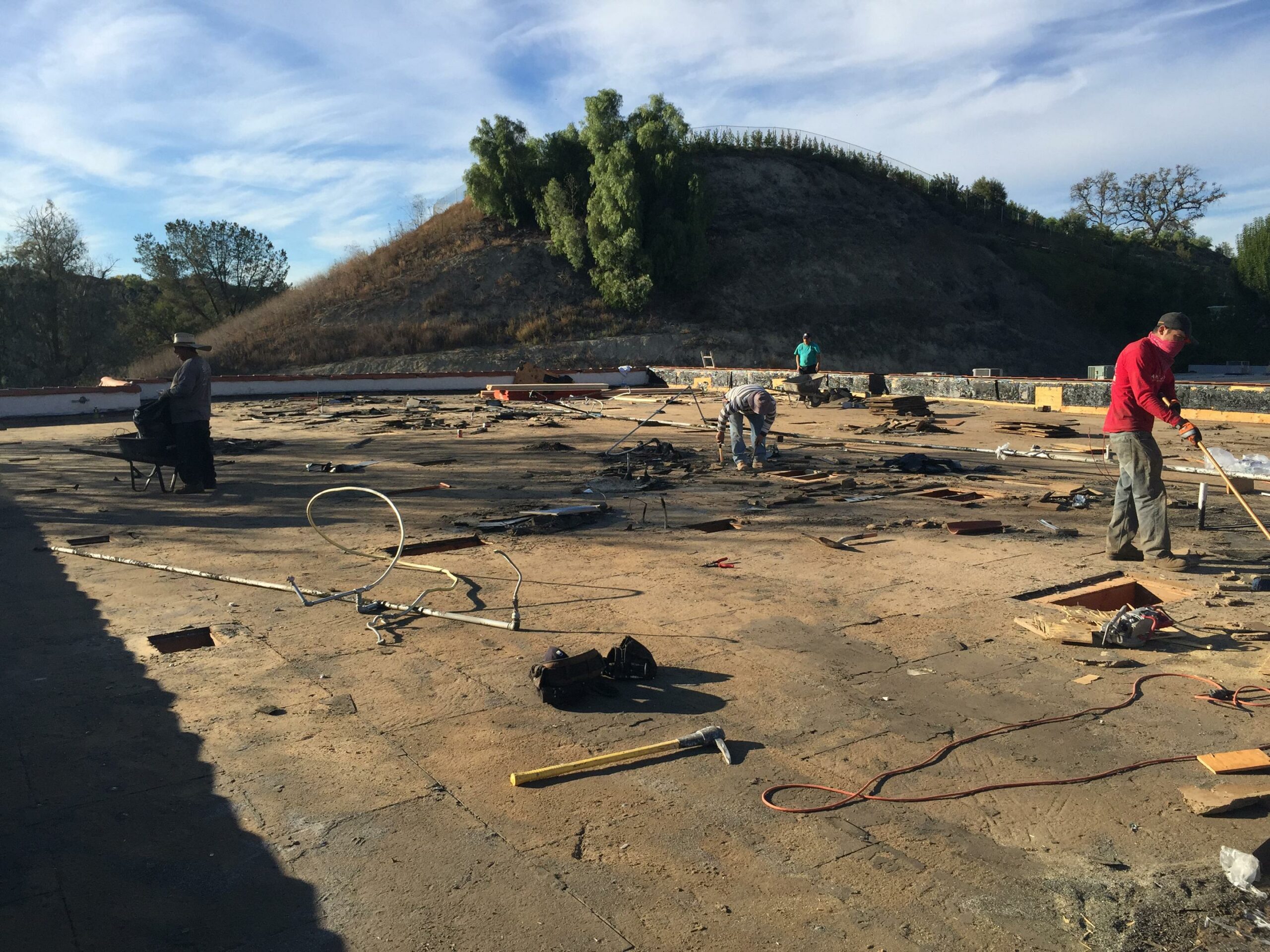 Workers on construction site clearing debris.