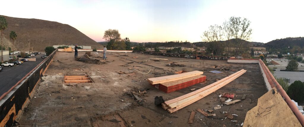 Panoramic view of a construction site on rooftop at dusk.