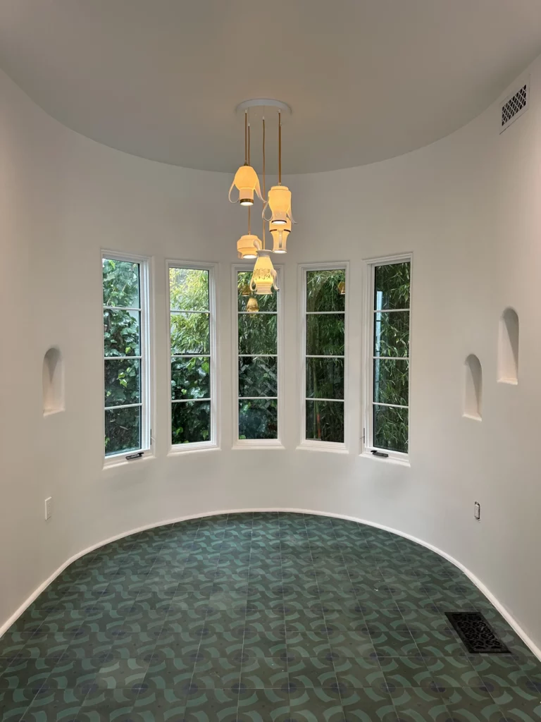 Round room with windows and modern chandelier.