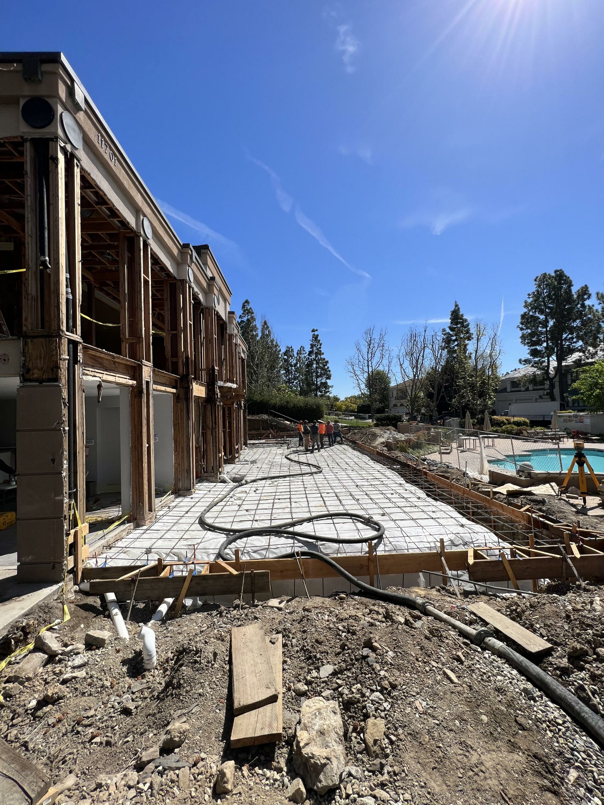 Construction site with rebar framework and workers.