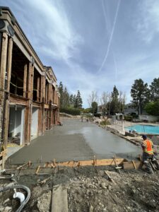 Construction site with workers pouring concrete.