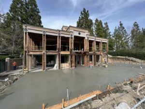 House under renovation with fresh concrete driveway.