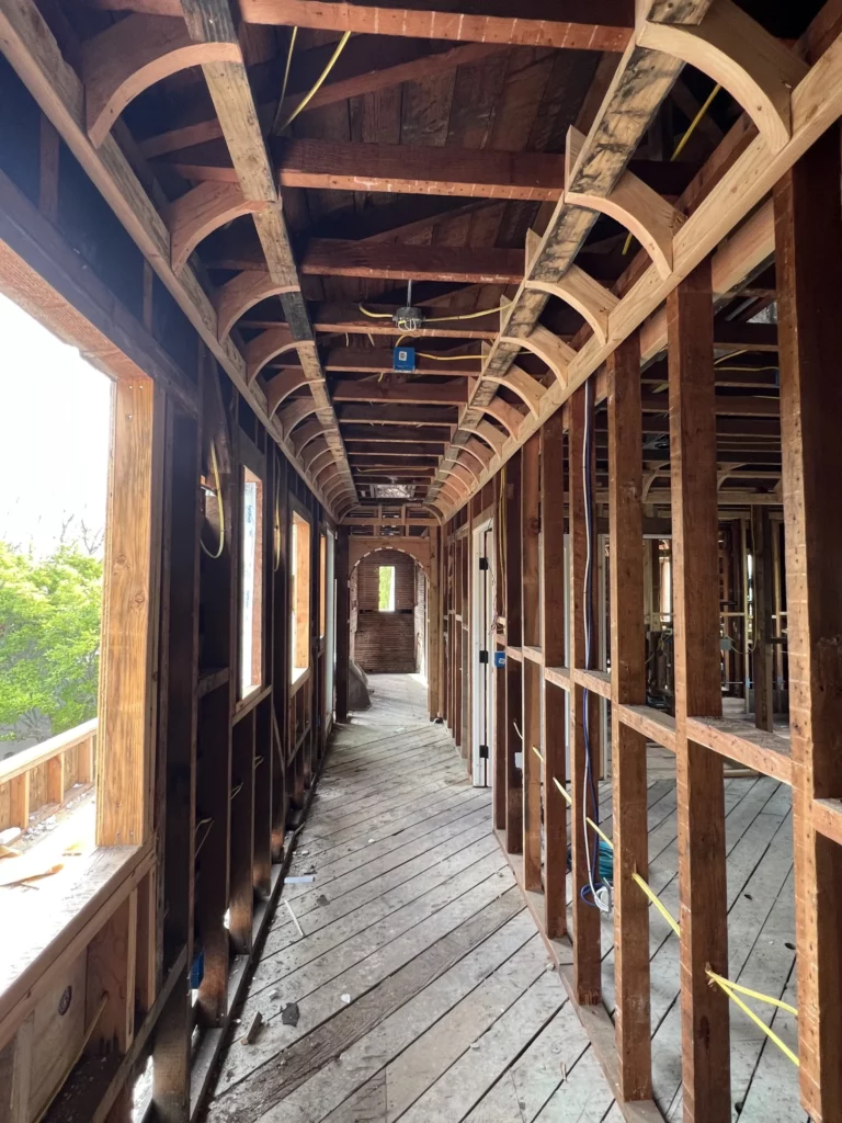 Interior of wooden-framed building under construction.
