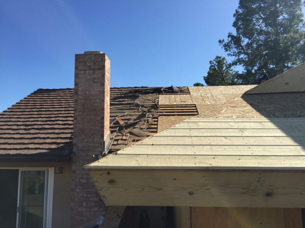 Damaged house roof needing repair.