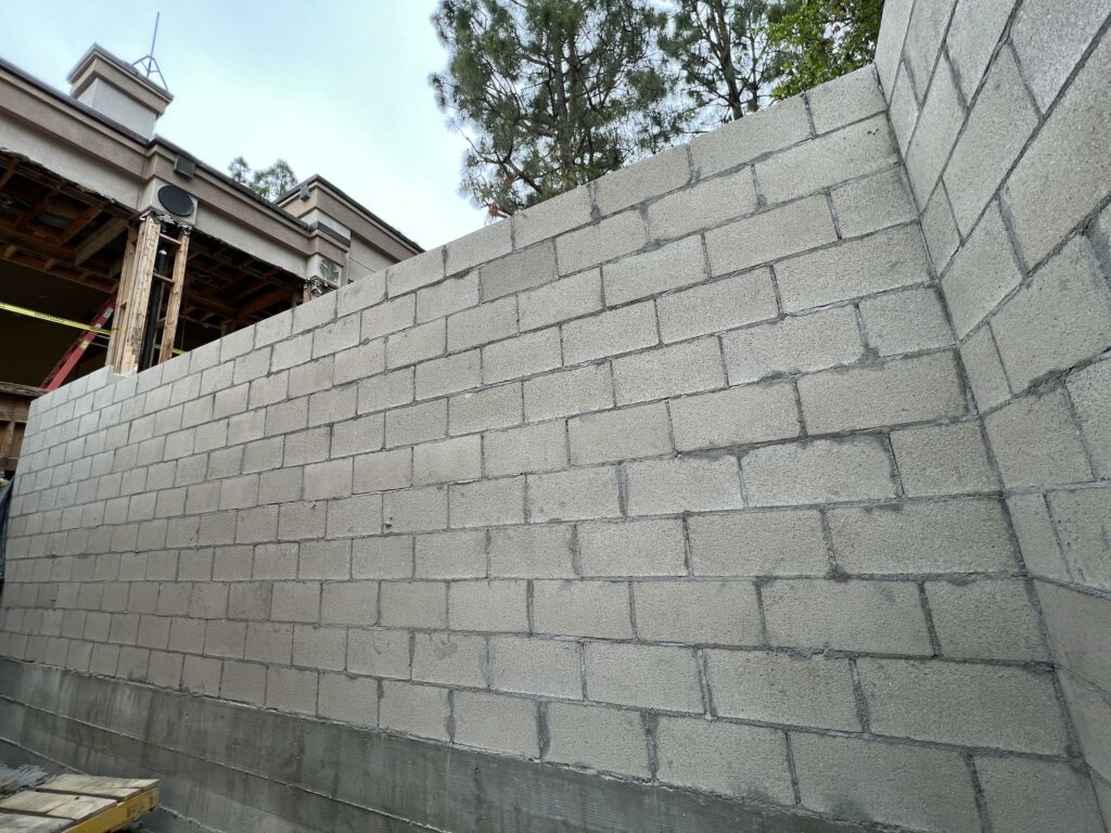 Newly constructed gray concrete block wall.