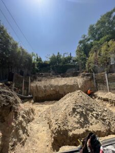 Construction site excavation with workers.