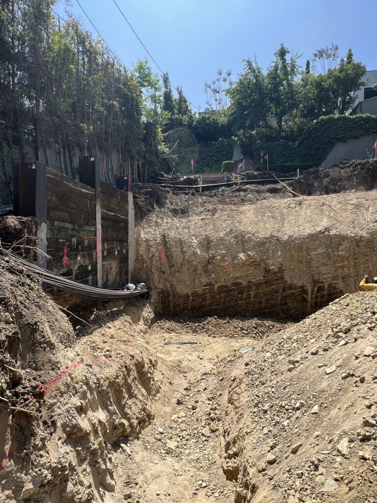 Large construction excavation site with retaining walls.