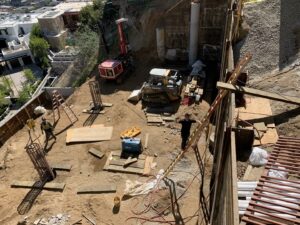 Active construction site with workers and machinery.