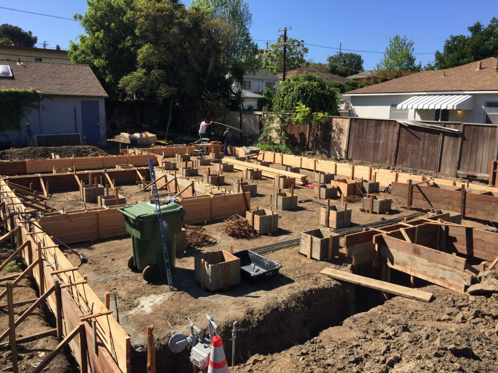 Residential construction site with wooden foundation frames.
