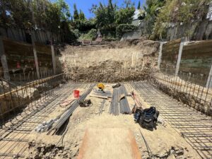 Construction site with rebar framework for foundation.
