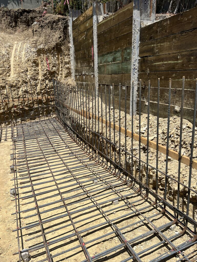 Construction site with rebar framework for concrete foundation.