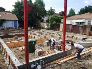 Construction site with workers building foundation.