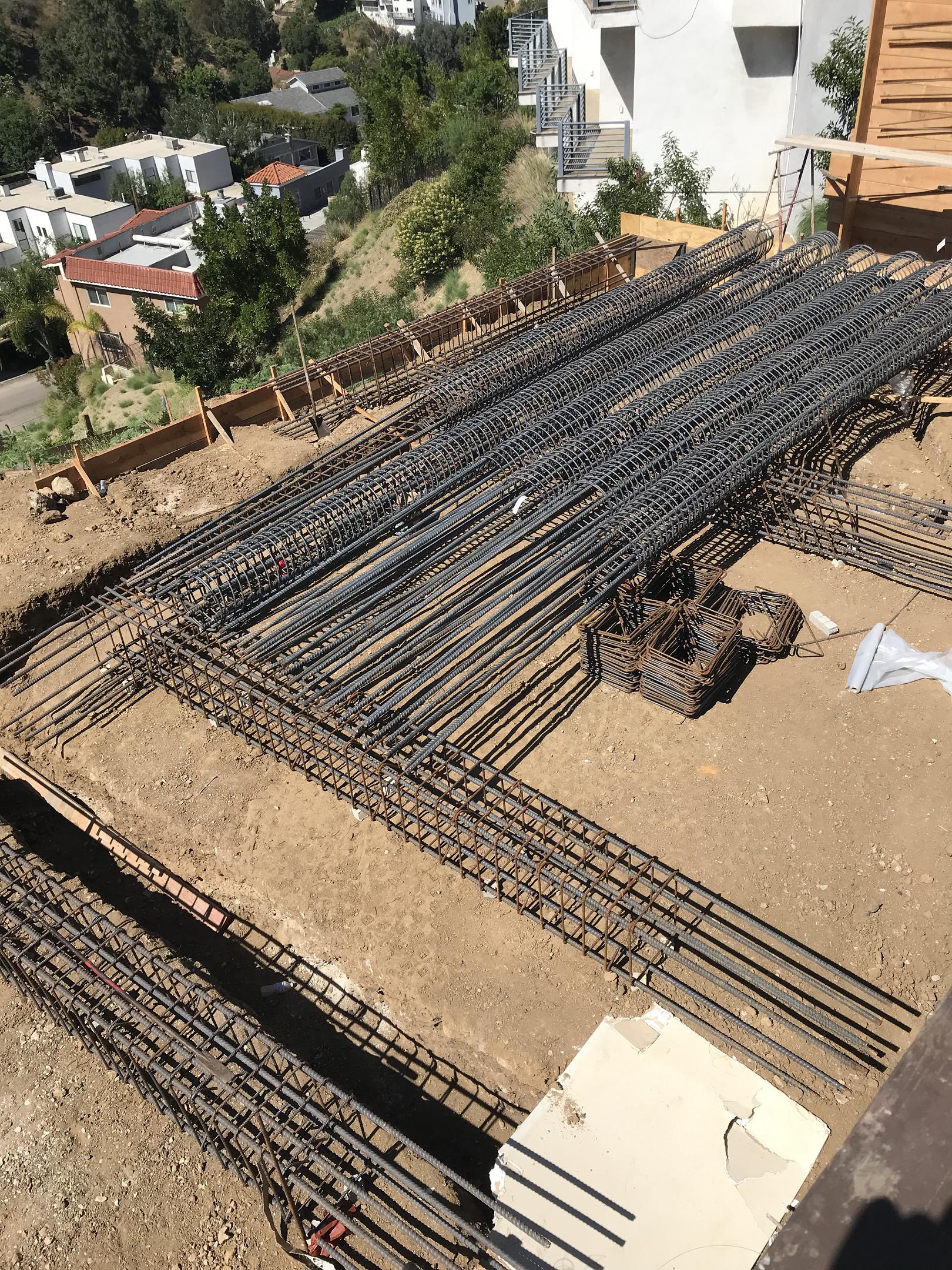 Construction site with rebar framework for concrete foundation.