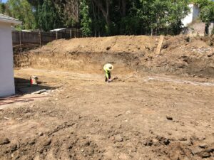 Worker at construction excavation site.
