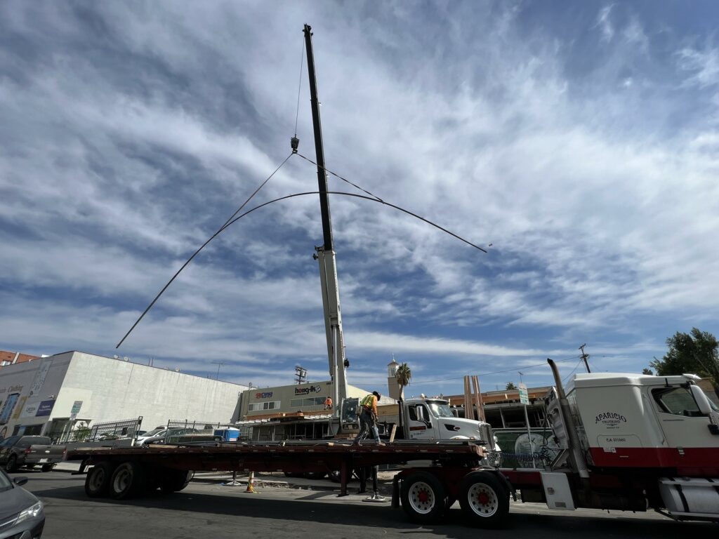 Crane lifting materials at urban construction site.