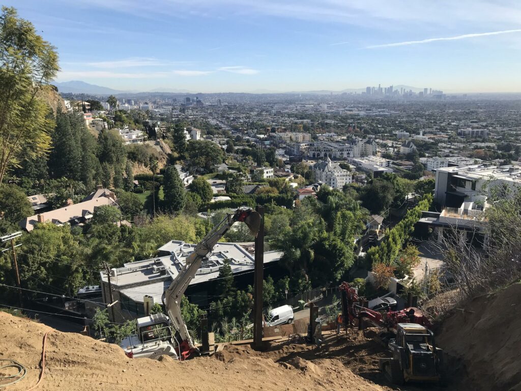 Los Angeles cityscape with construction equipment foreground.