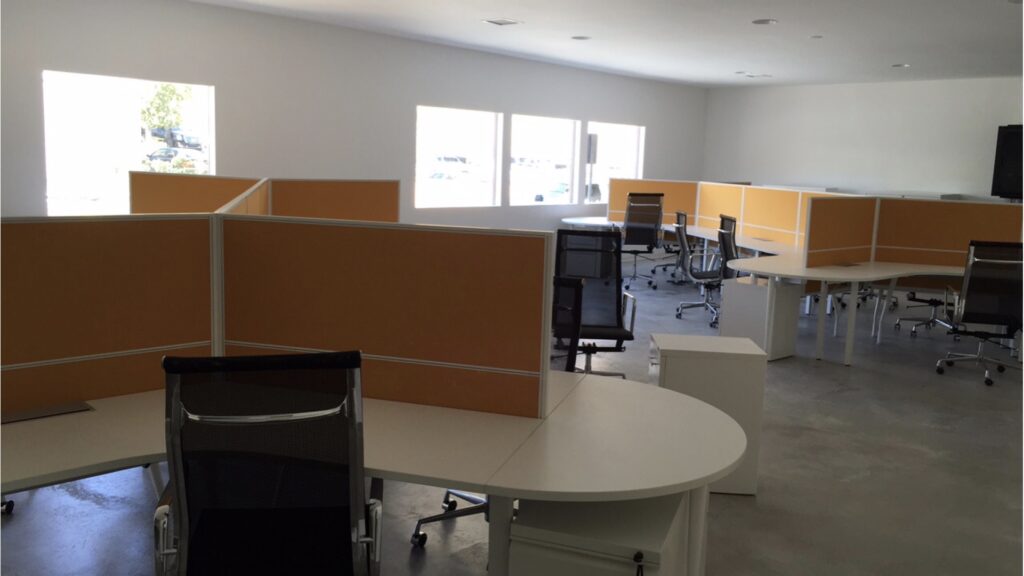 Modern office interior with desks and chairs.