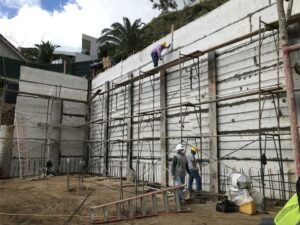 Construction workers on scaffolding at building site.