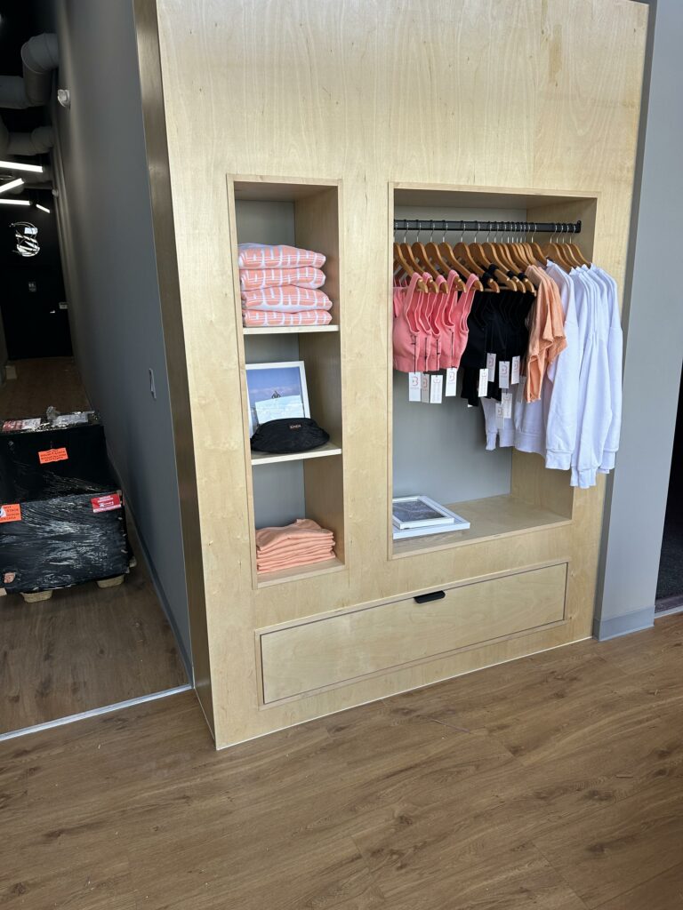 Modern clothing boutique interior with wooden display.