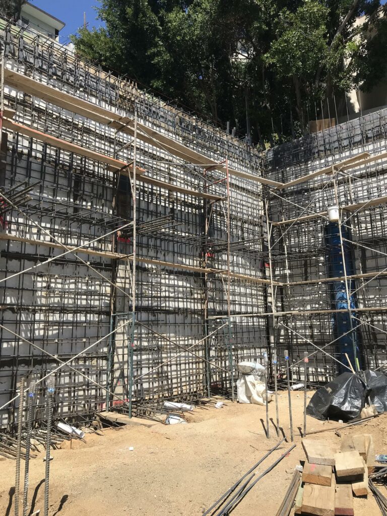 Complex construction scaffolding at building site.