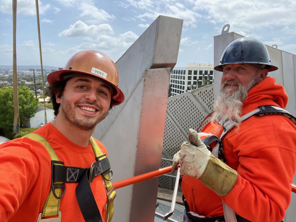 Two construction workers taking a selfie on site.