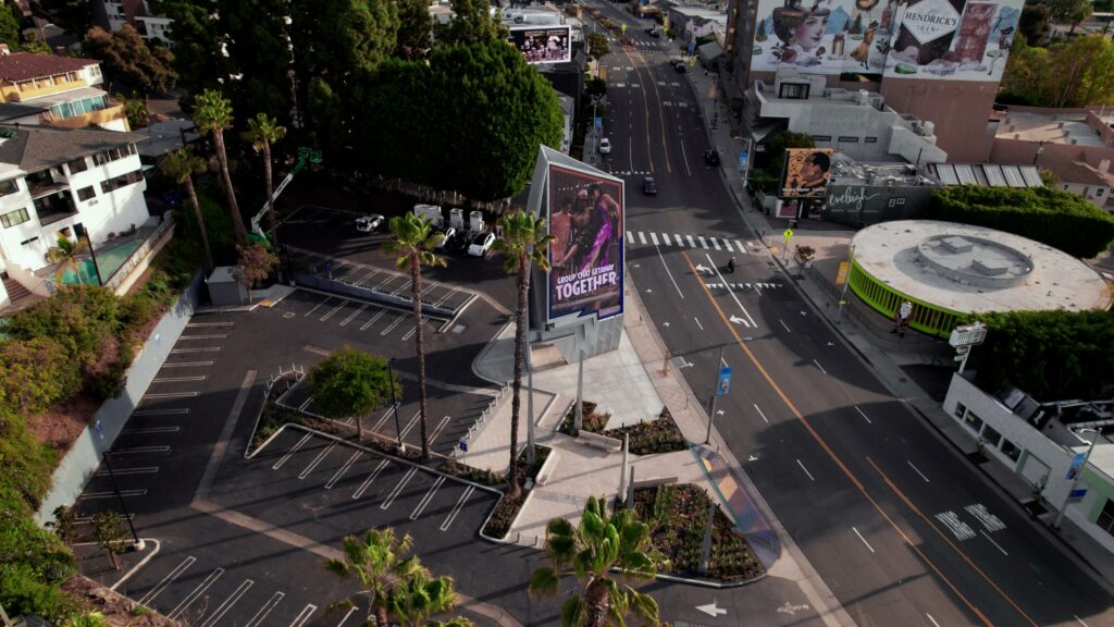 Aerial view of urban intersection with billboards.