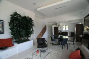 Modern living room with staircase and open-plan layout.