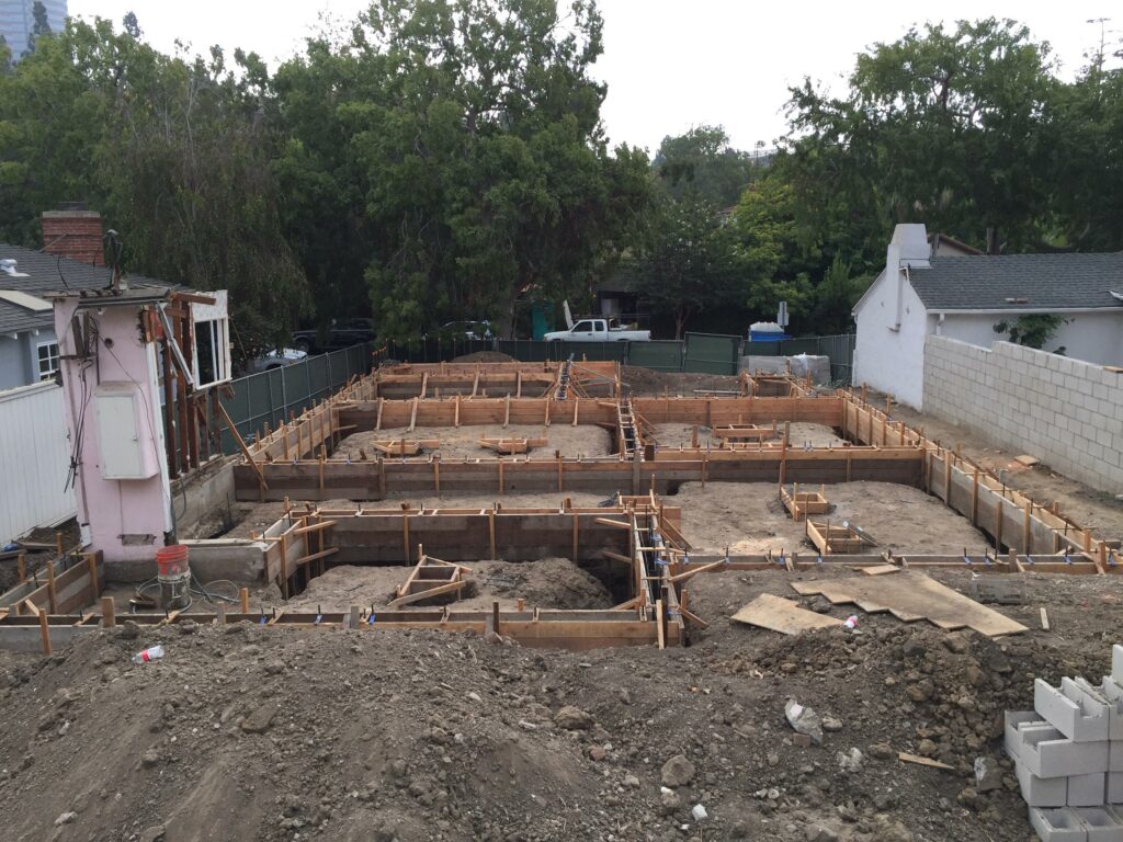 Residential foundation construction with wooden formwork.