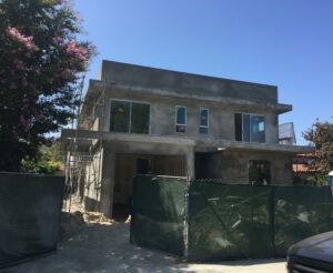 Modern house under construction with scaffolding.